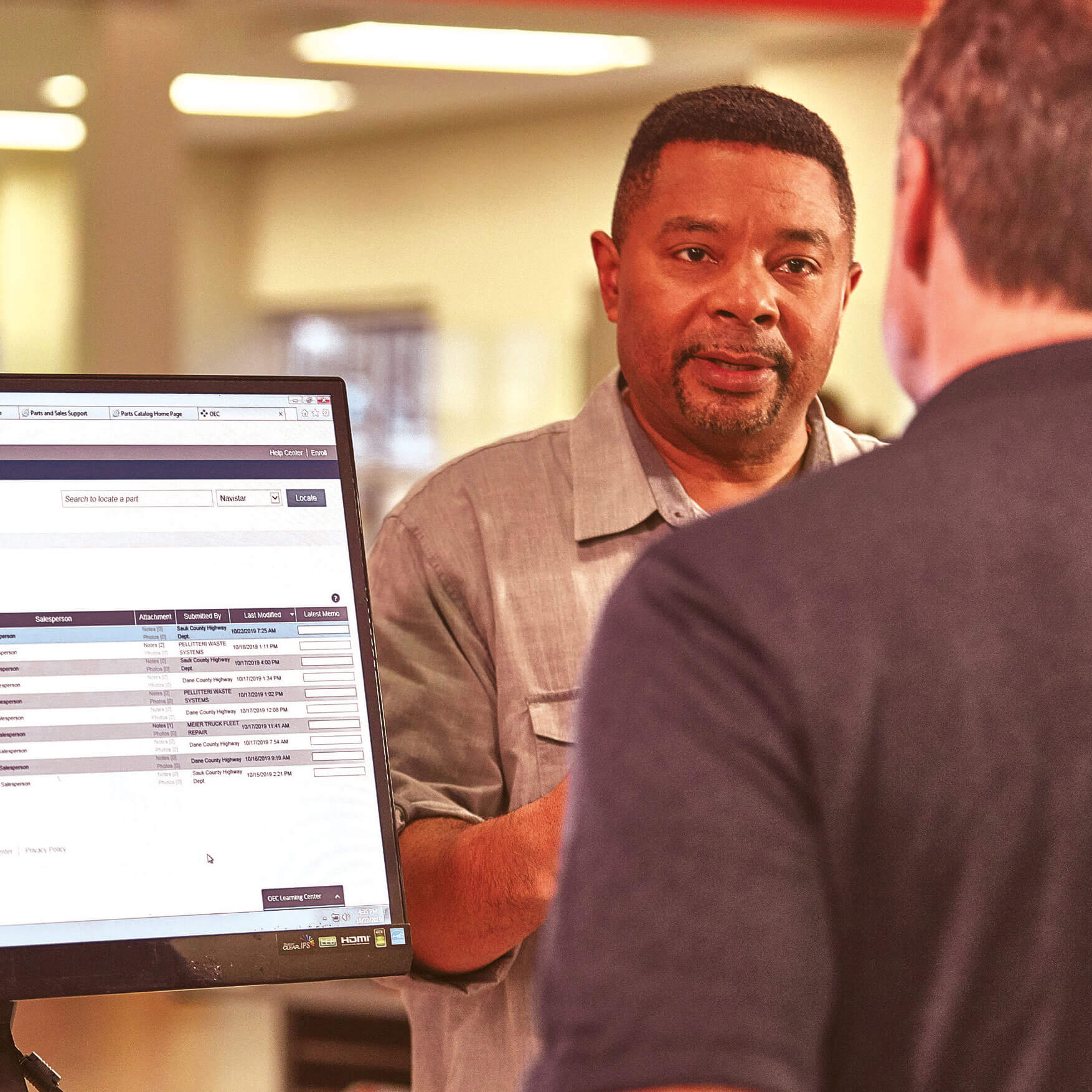 Man Purchasing Parts at Counter