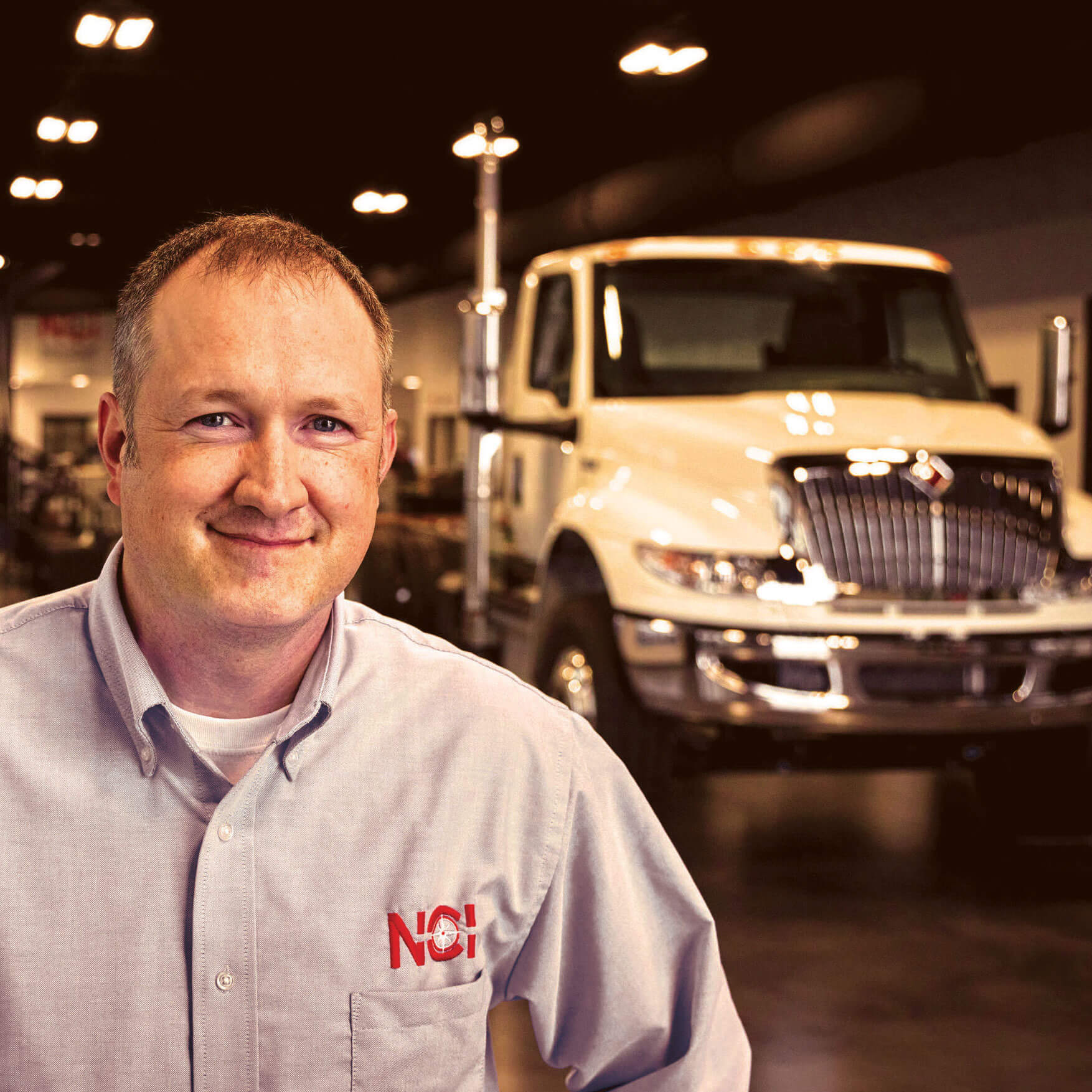 Man Standing In Front of International Truck